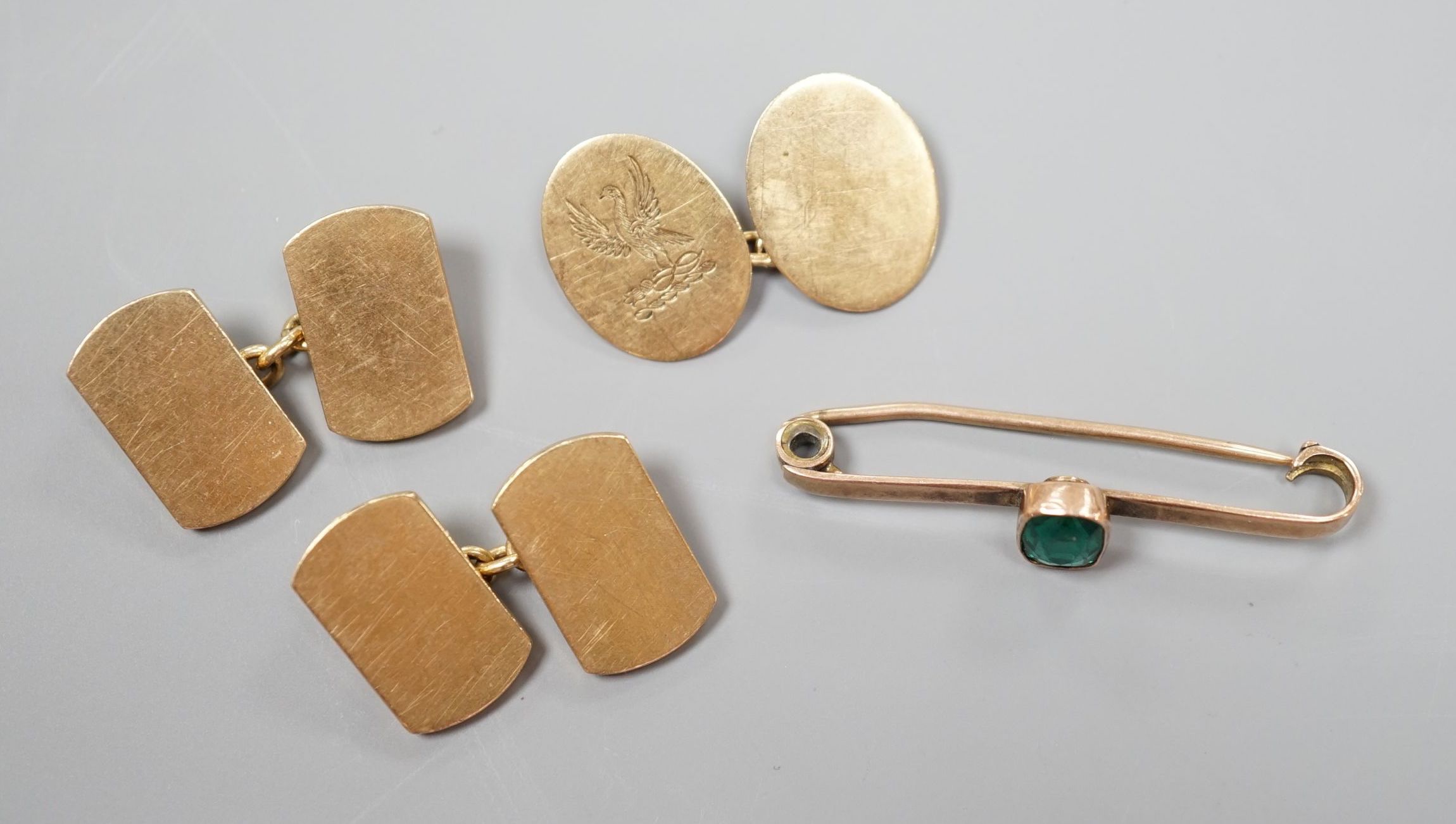 A pair of 9ct gold cufflinks, one other single 9ct gold cufflink and a 9ct and gem set bar brooch